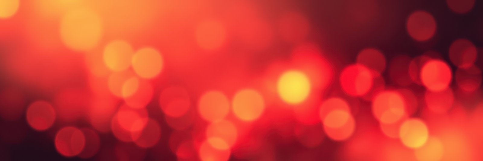 Vibrant bokeh lights create a warm atmosphere at an evening gathering in a city park